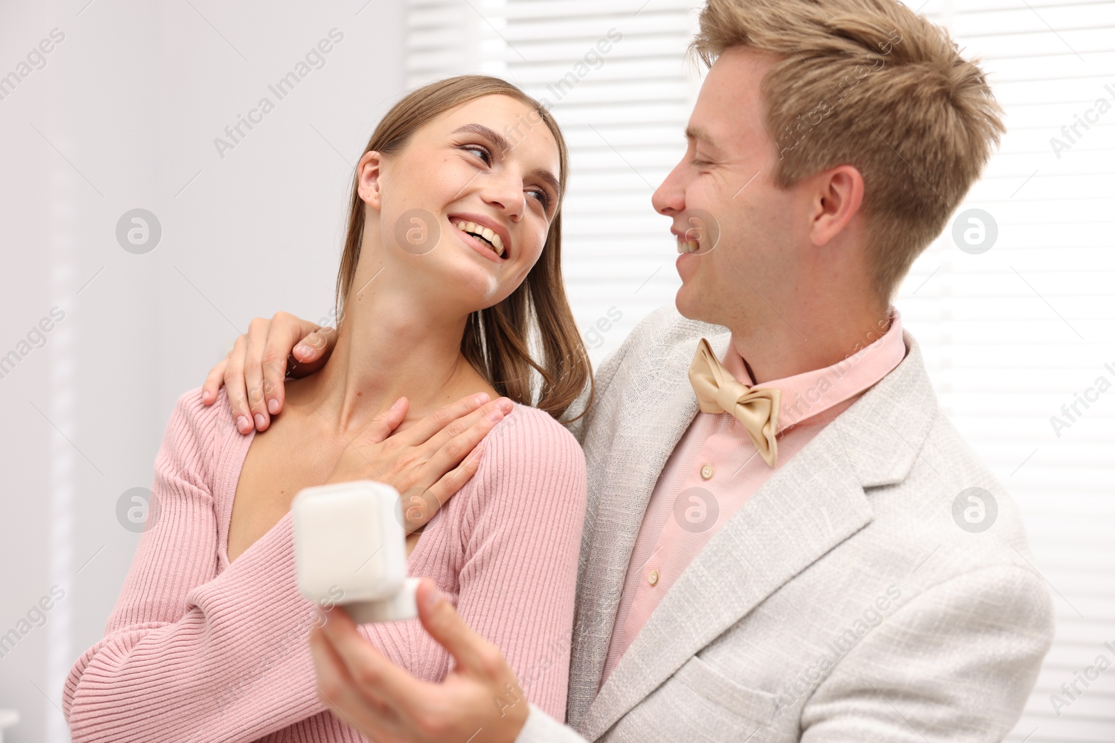 Marriage proposal. Smiling man with engagement ring and his happy girlfriend at home Photo of Marriage proposal. Smiling man with engagement ring and his happy girlfriend at home
