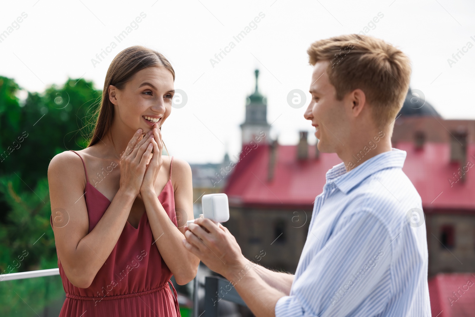 Man with engagement ring making marriage proposal to his happy girlfriend outdoors Photo of Man with engagement ring making marriage proposal to his happy girlfriend outdoors