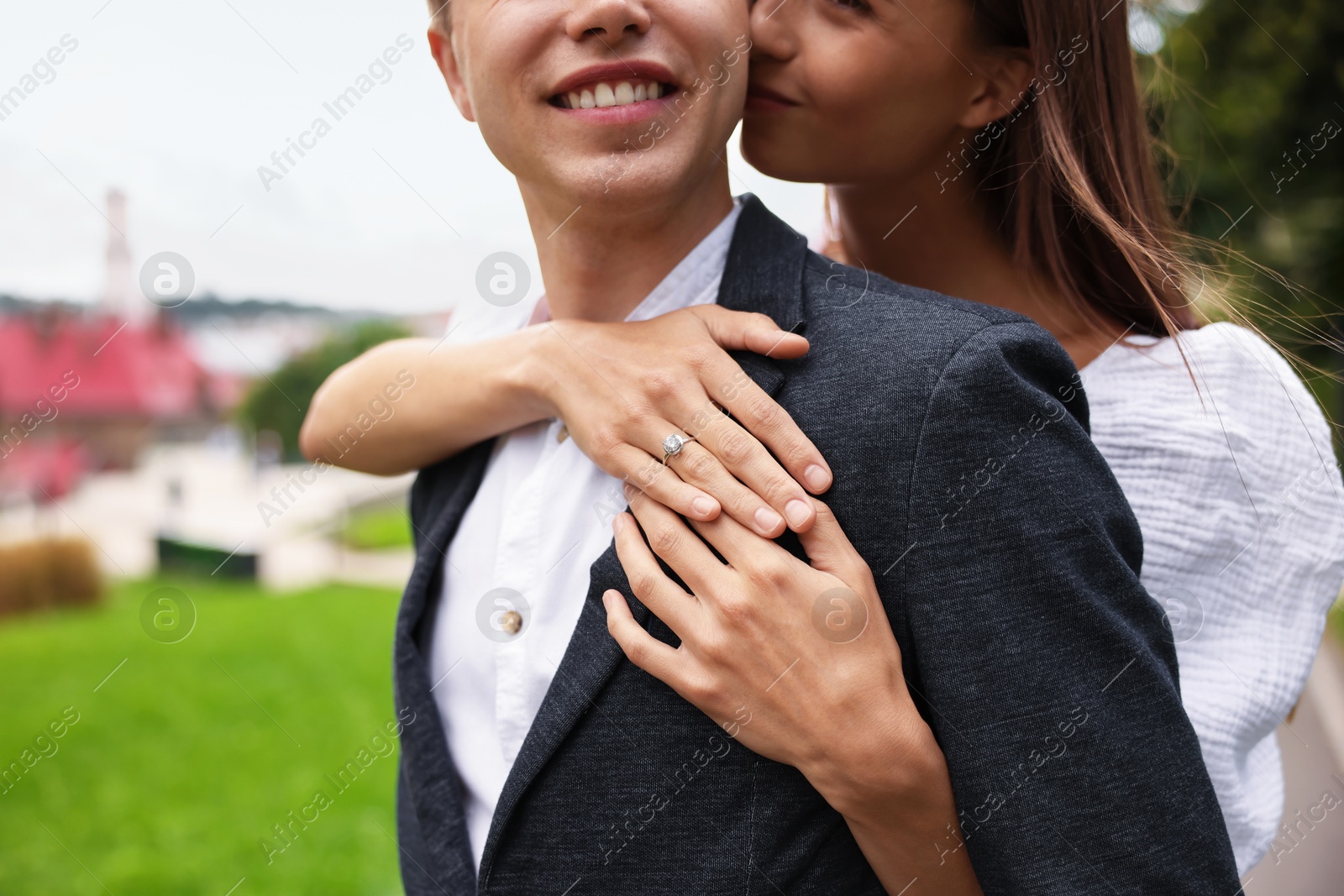 Marriage proposal. Woman with engagement ring hugging her smiling fiance outdoors, closeup Photo of Marriage proposal. Woman with engagement ring hugging her smiling fiance outdoors, closeup