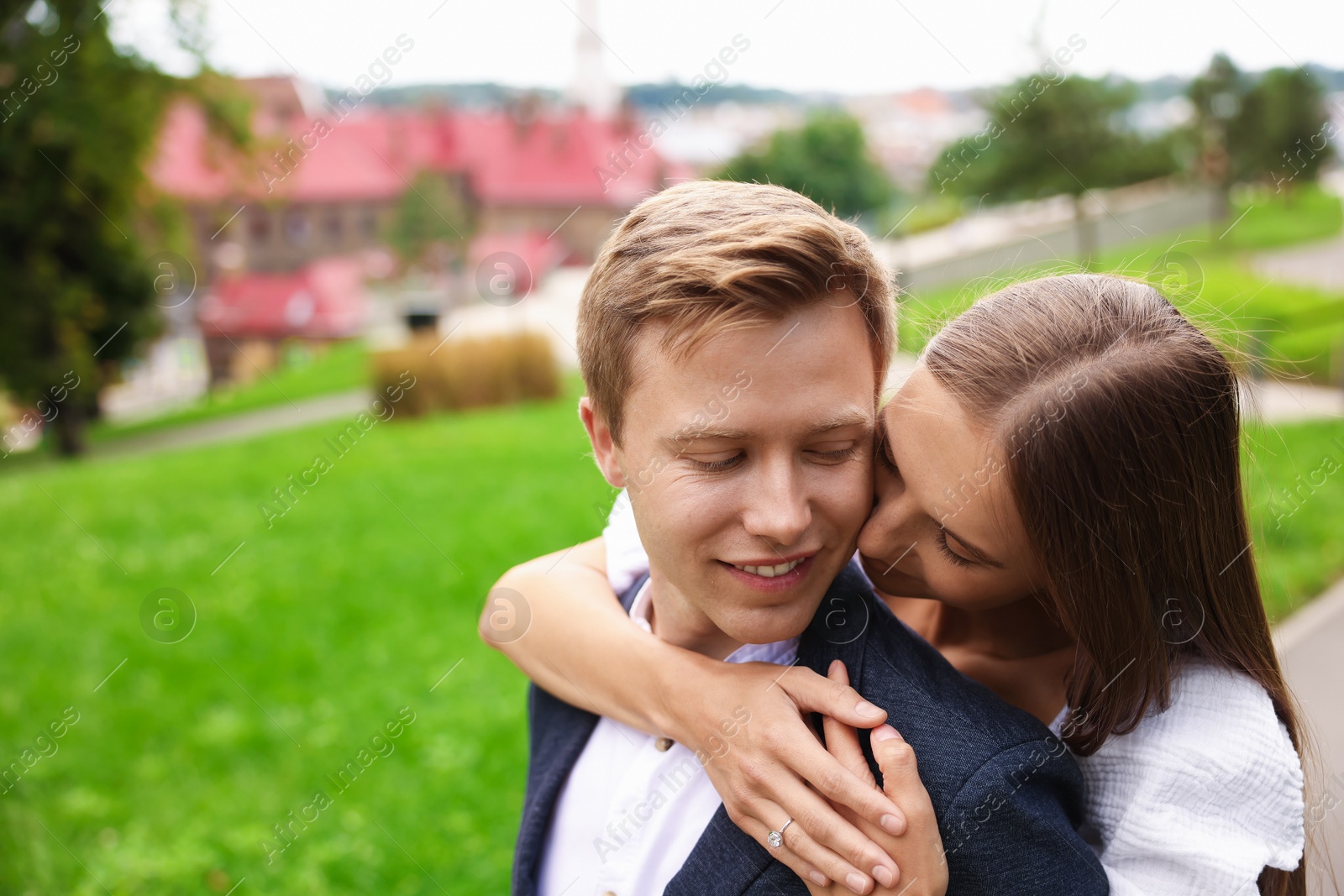 Marriage proposal. Woman with engagement ring hugging her smiling fiance outdoors, space for text Photo of Marriage proposal. Woman with engagement ring hugging her smiling fiance outdoors, space for text