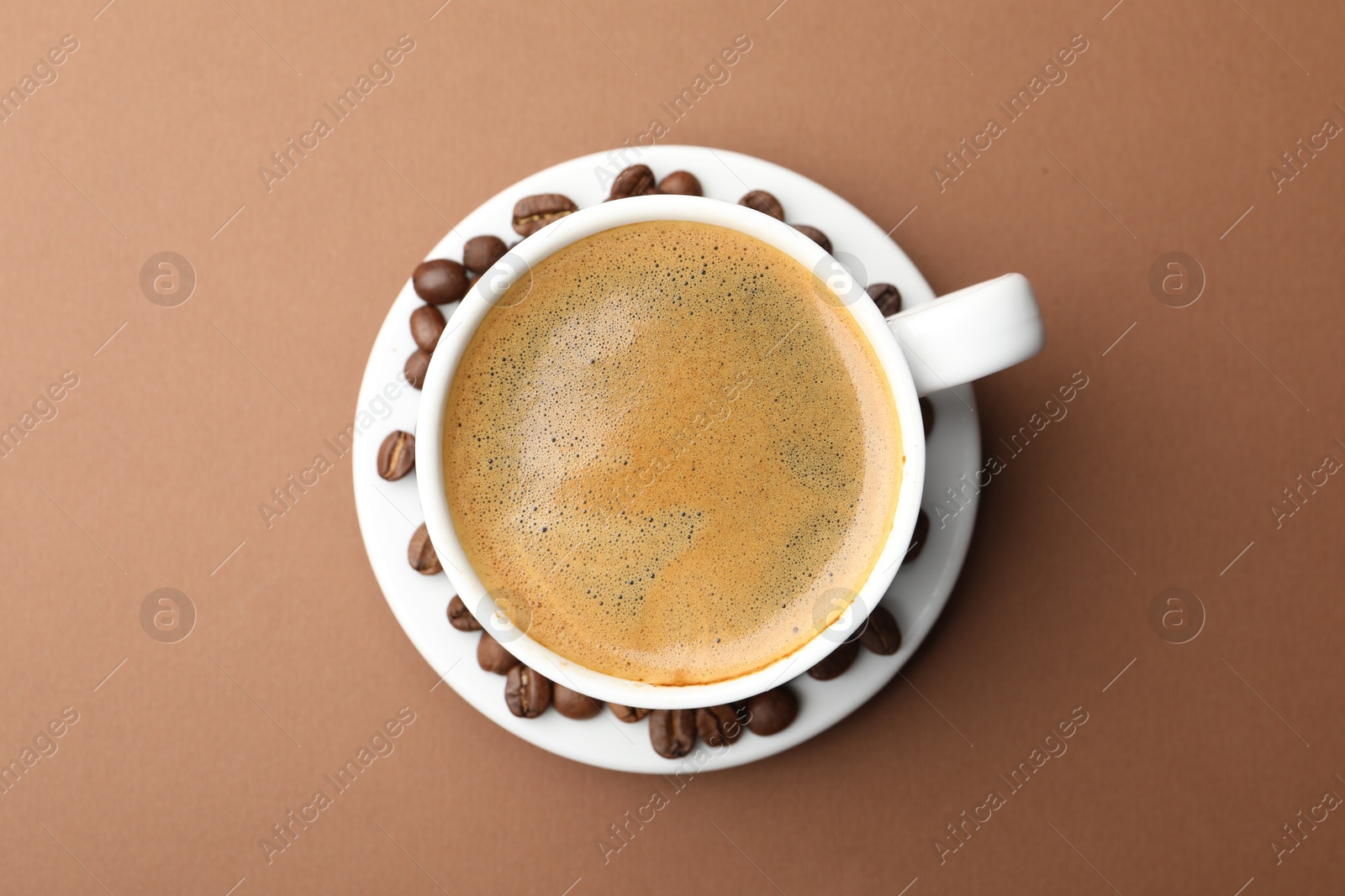 Cup of hot coffee on brown background, top view Photo of Cup of hot coffee on brown background, top view
