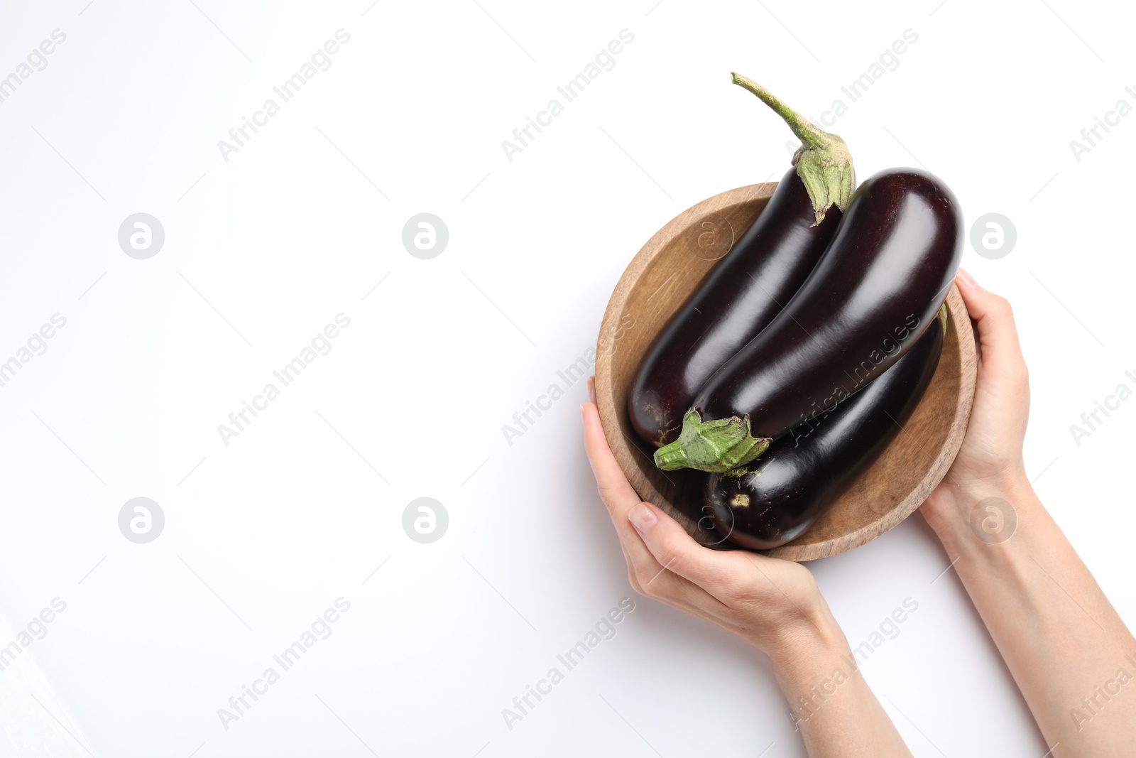 Woman with bowl of fresh eggplants on white background, top view. Space for text Photo of Woman with bowl of fresh eggplants on white background, top view. Space for text