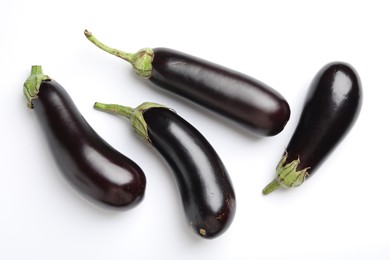 Photo of Many fresh eggplants on white background, flat lay