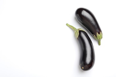 Photo of Fresh eggplants on white background, top view. Space for text