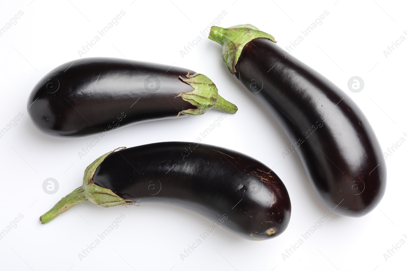 Many fresh eggplants on white background, flat lay Photo of Many fresh eggplants on white background, flat lay