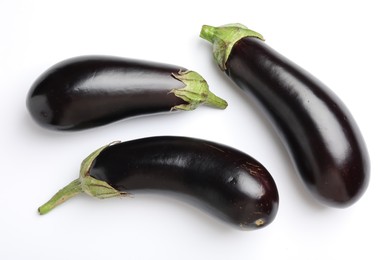 Photo of Many fresh eggplants on white background, flat lay