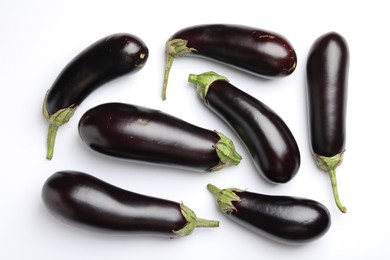 Photo of Many fresh eggplants on white background, flat lay