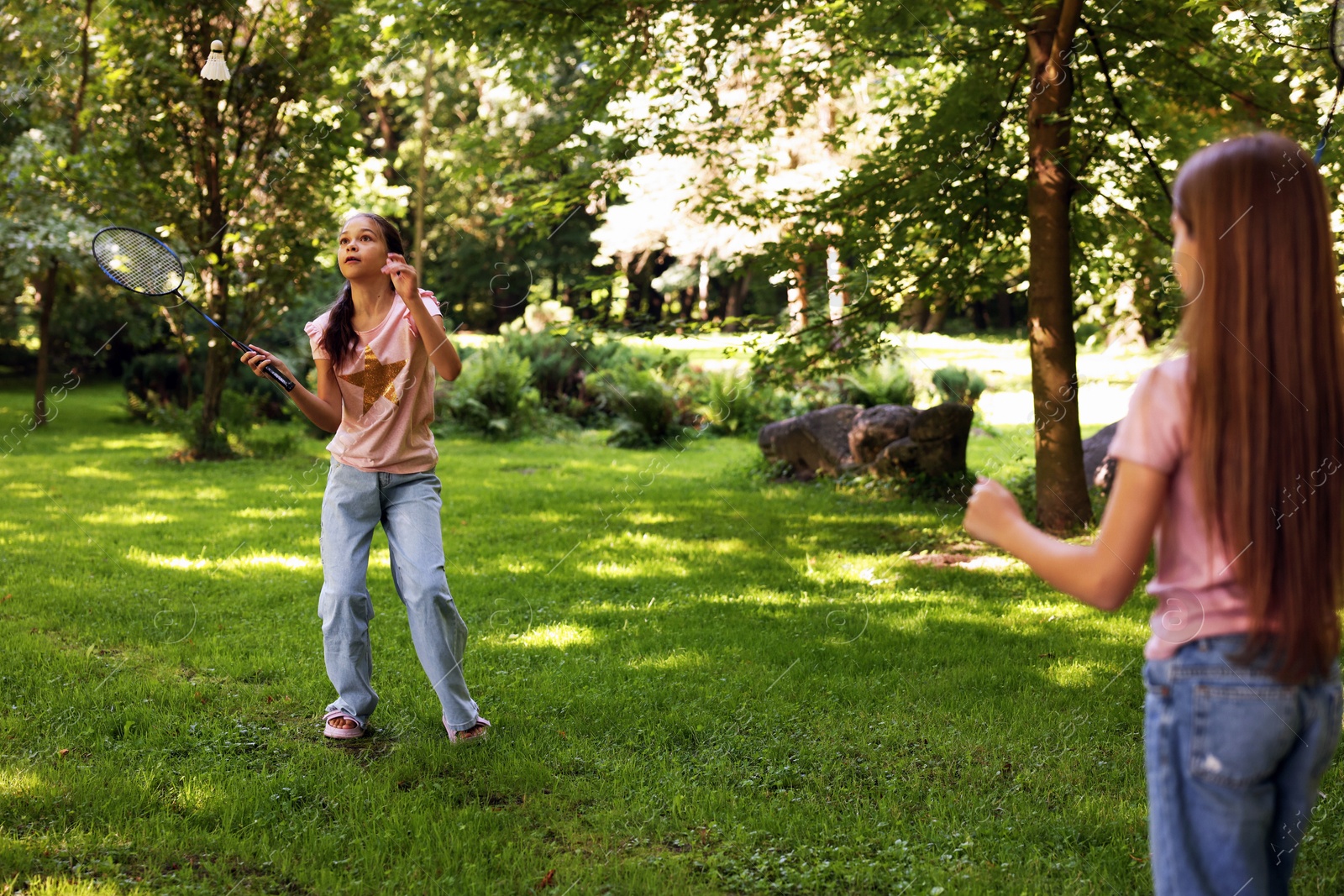 Cute little girls playing badminton in park Photo of Cute little girls playing badminton in park