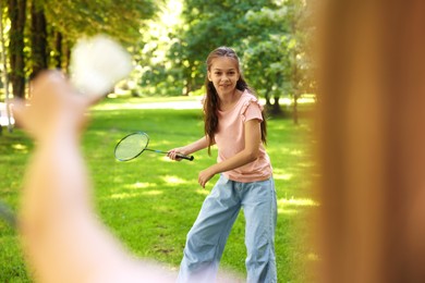 Photo of Cute little girls playing badminton in park, closeup