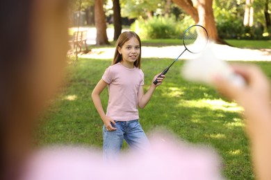 Photo of Cute little girls playing badminton in park, closeup