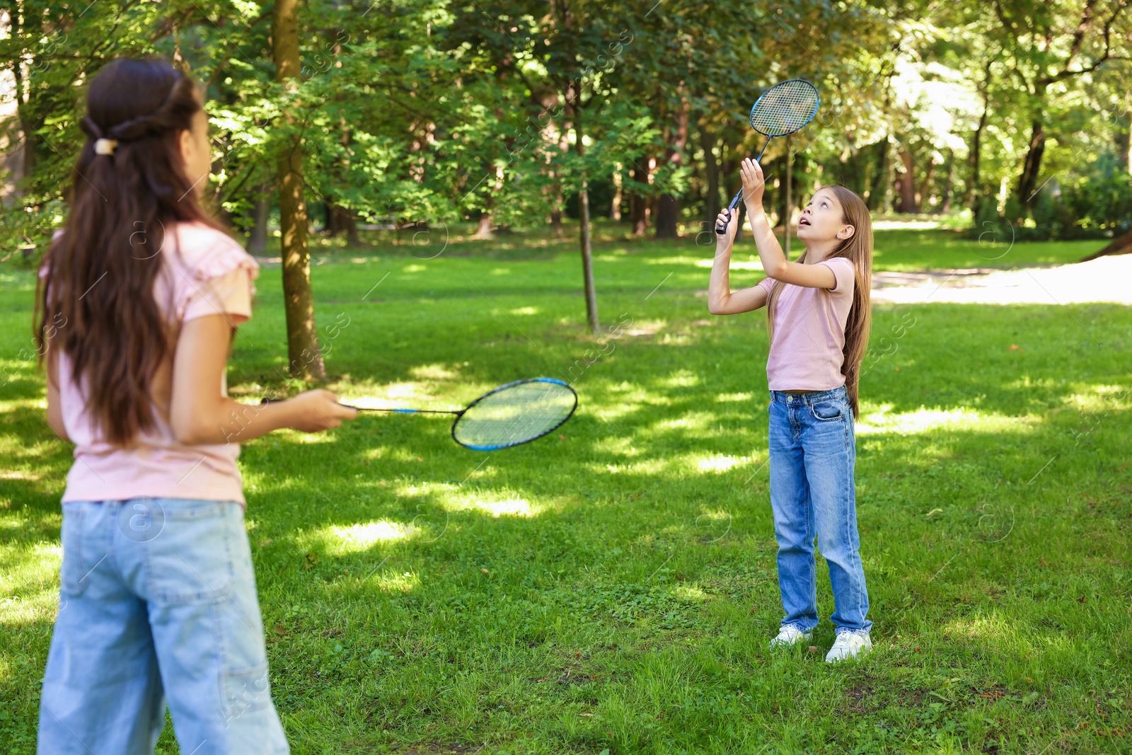 Cute little girls playing badminton in park Photo of Cute little girls playing badminton in park