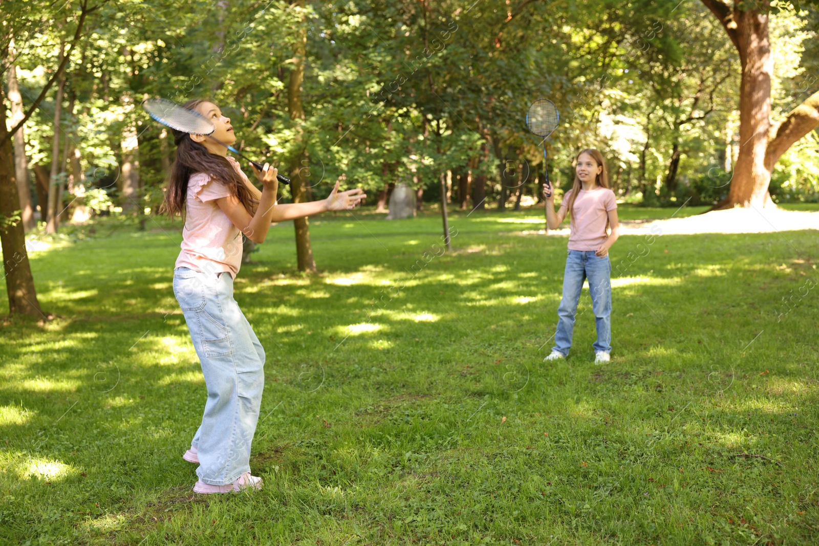 Cute little girls playing badminton in park Photo of Cute little girls playing badminton in park