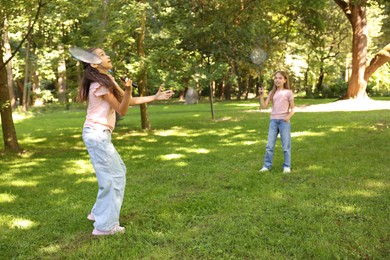 Photo of Cute little girls playing badminton in park