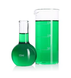 Photo of Flask and beaker with green liquid on mirror surface isolated on white