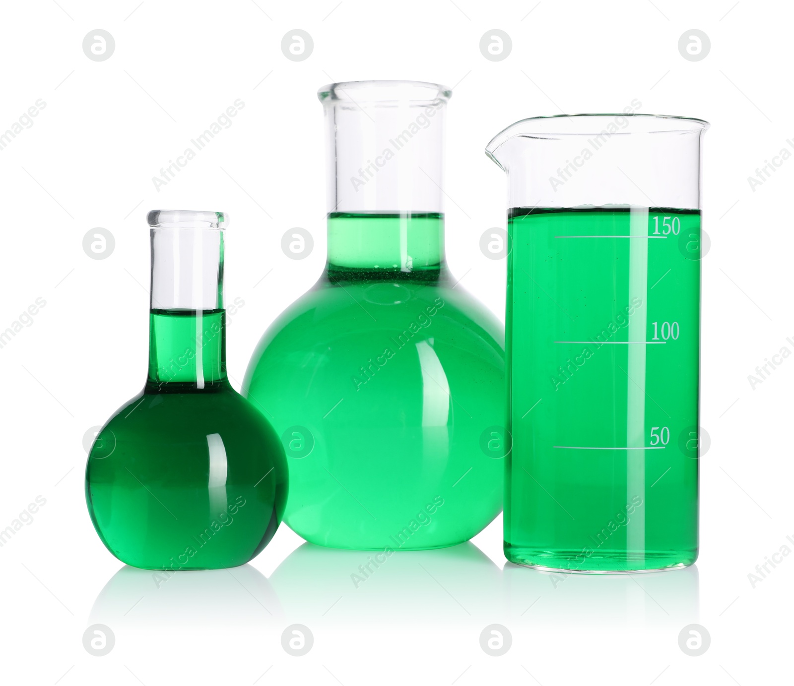 Flasks and beaker with green liquid on mirror surface isolated on white Photo of Flasks and beaker with green liquid on mirror surface isolated on white