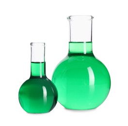 Photo of Flasks with green liquid isolated on white