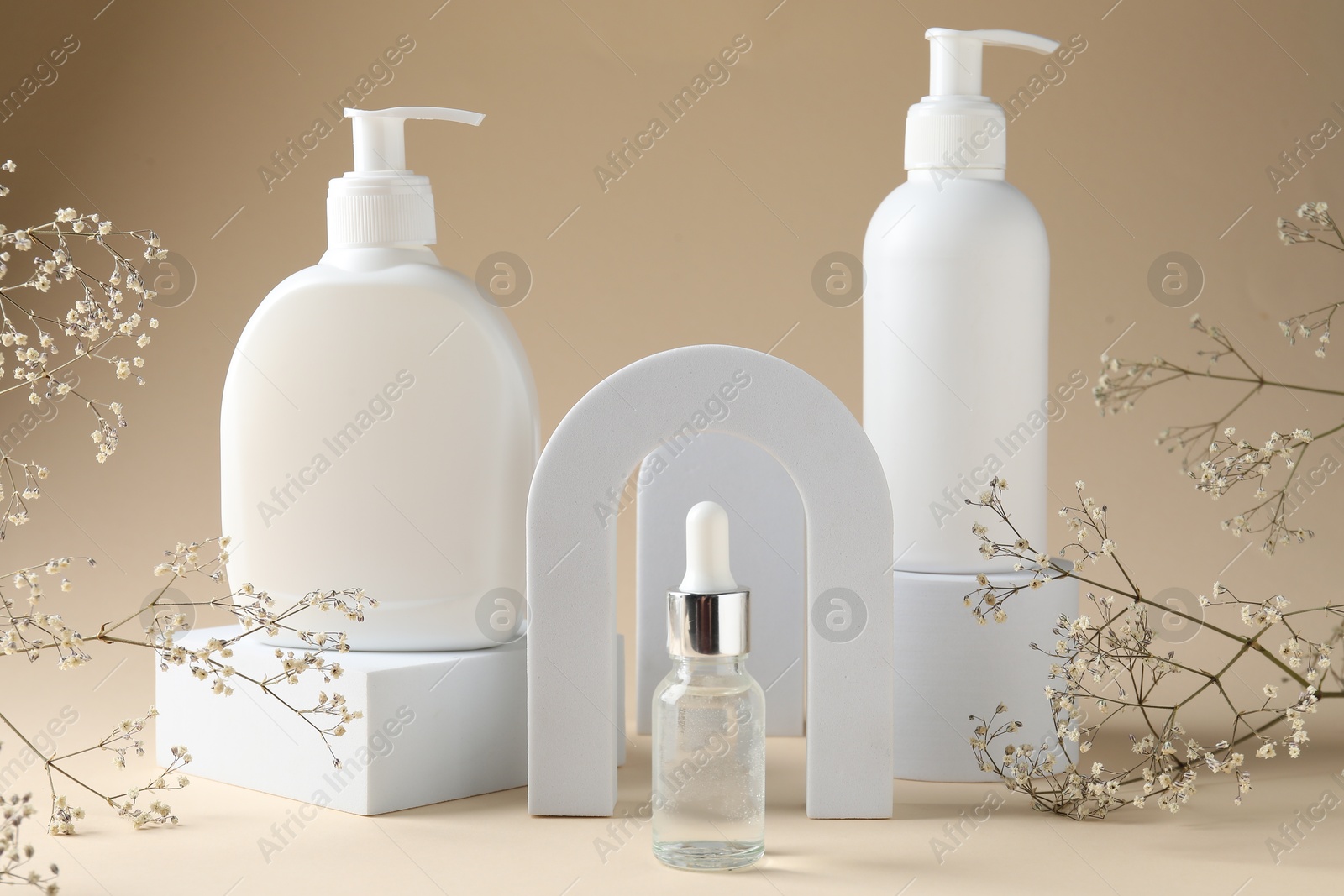 Promotion. Cosmetic products, podiums and gypsophila flowers on beige background Photo of Promotion. Cosmetic products, podiums and gypsophila flowers on beige background