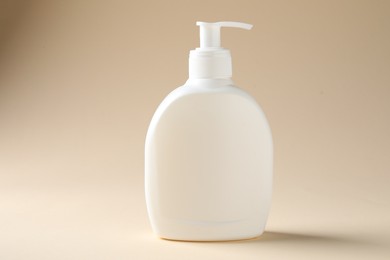 Photo of Promotion. Bottle of cosmetic product on beige background