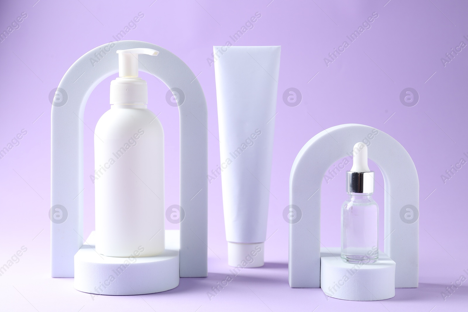 Promotion. Cosmetic products and podiums on violet background Photo of Promotion. Cosmetic products and podiums on violet background