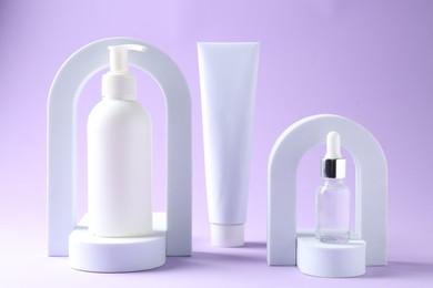 Photo of Promotion. Cosmetic products and podiums on violet background