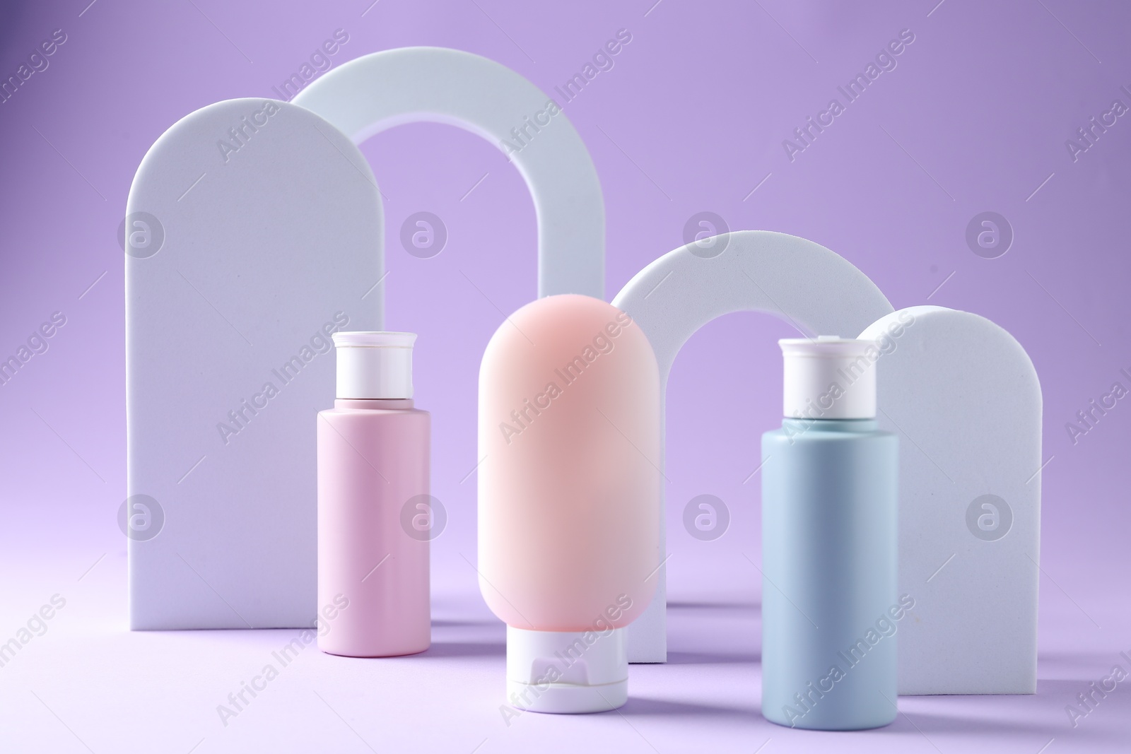 Promotion. Cosmetic products and podiums on violet background Photo of Promotion. Cosmetic products and podiums on violet background