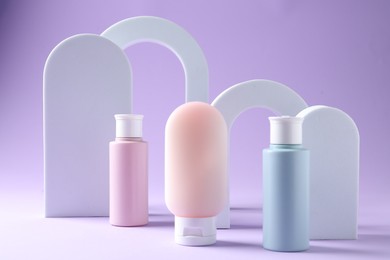 Photo of Promotion. Cosmetic products and podiums on violet background