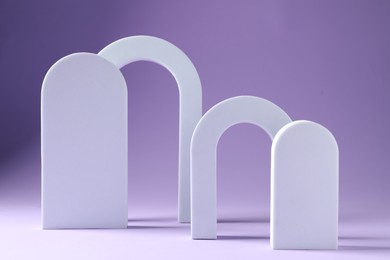 Photo of Promotion. Different podiums for product presentation on violet background
