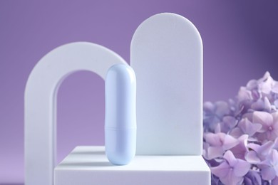 Photo of Promotion. Cosmetic product, podiums and hydrangea flowers on violet background, closeup