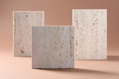 Photo of Promotion. Podiums for product presentation on brown background, closeup