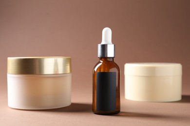 Photo of Promotion. Different cosmetic products on brown background, closeup