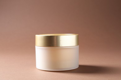 Photo of Promotion. Jar of cosmetic product on brown background