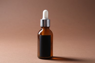 Photo of Promotion. Bottle of cosmetic product on brown background