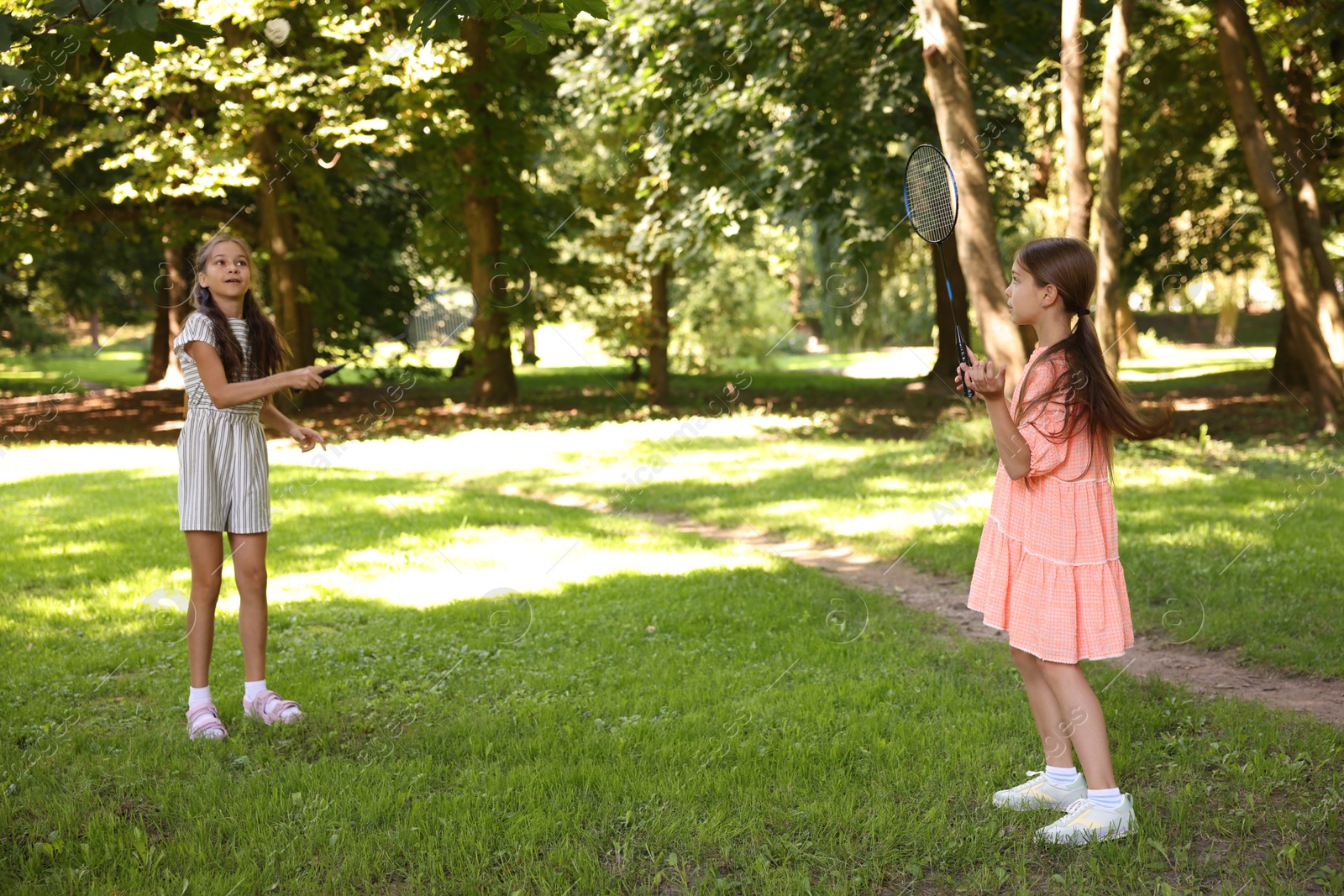 Cute little girls playing badminton in park Photo of Cute little girls playing badminton in park