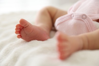 Photo of Cute newborn baby lying on bed, closeup