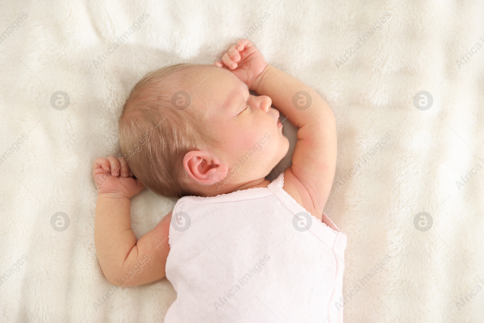 Cute newborn baby sleeping on bed, top view Photo of Cute newborn baby sleeping on bed, top view