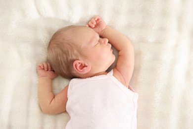 Photo of Cute newborn baby sleeping on bed, top view