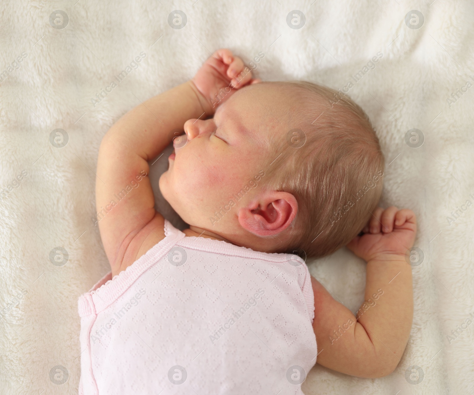 Cute newborn baby sleeping on bed, top view Photo of Cute newborn baby sleeping on bed, top view