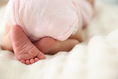 Photo of Cute newborn baby lying on bed, closeup