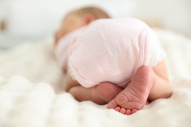Photo of Cute newborn baby lying on bed, closeup