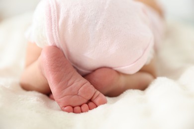 Photo of Cute newborn baby lying on bed, closeup