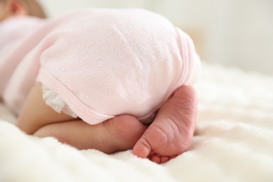 Photo of Cute newborn baby lying on bed, closeup