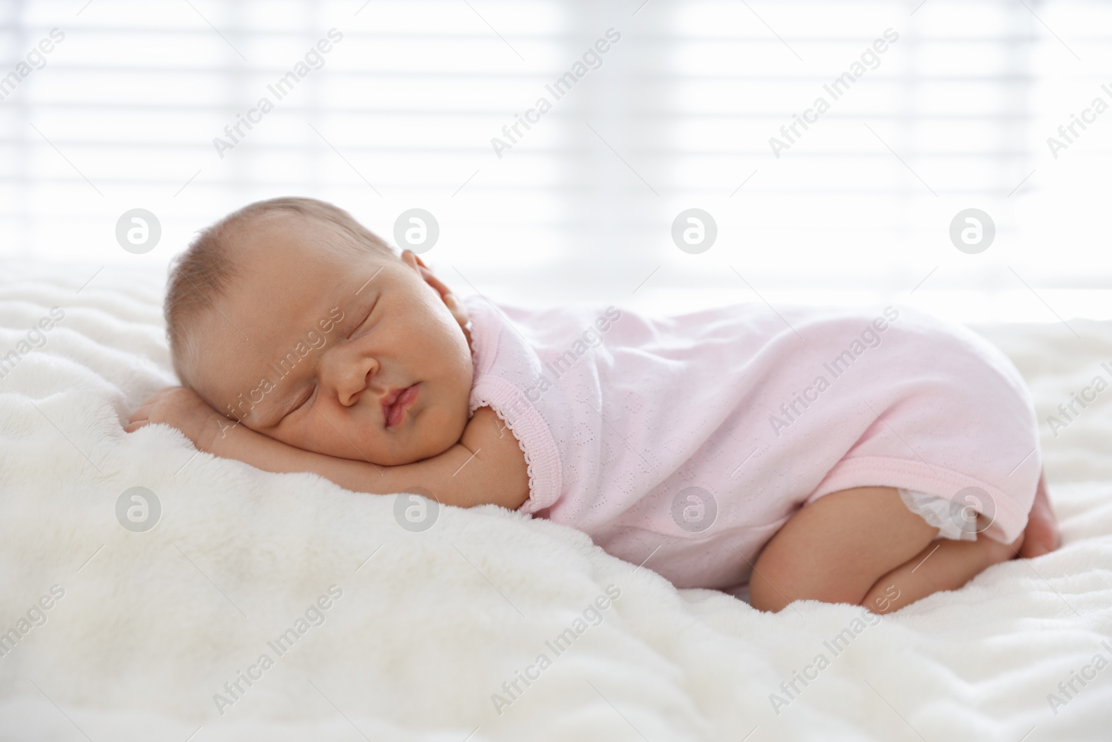 Cute newborn baby sleeping on bed indoors Photo of Cute newborn baby sleeping on bed indoors