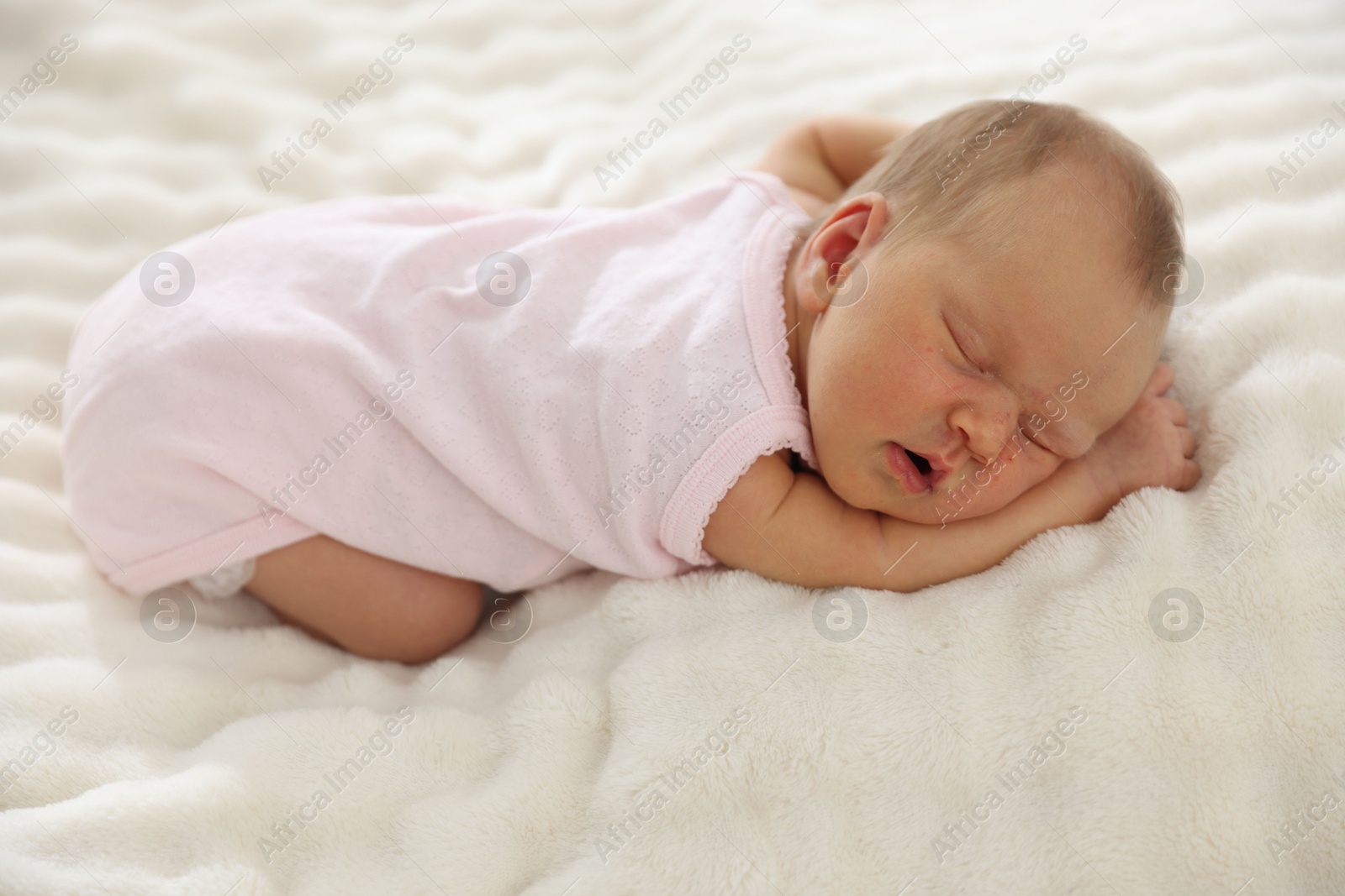 Cute newborn baby sleeping on bed indoors Photo of Cute newborn baby sleeping on bed indoors