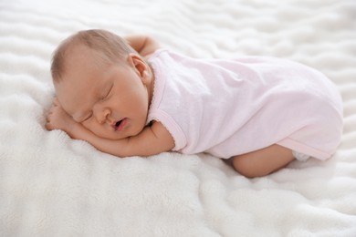 Photo of Cute newborn baby sleeping on bed indoors