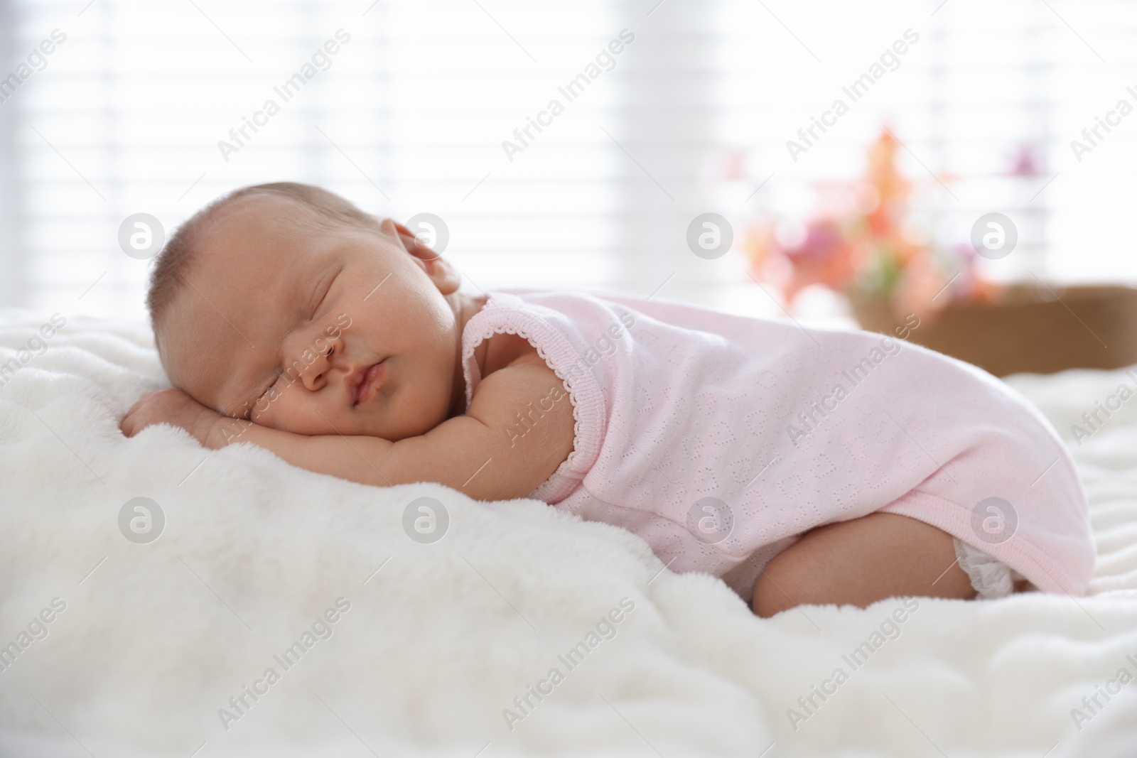 Cute newborn baby sleeping on bed indoors Photo of Cute newborn baby sleeping on bed indoors