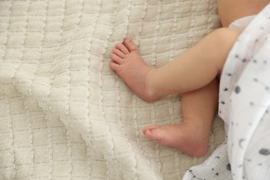 Photo of Cute newborn baby lying on bed, top view. Space for text
