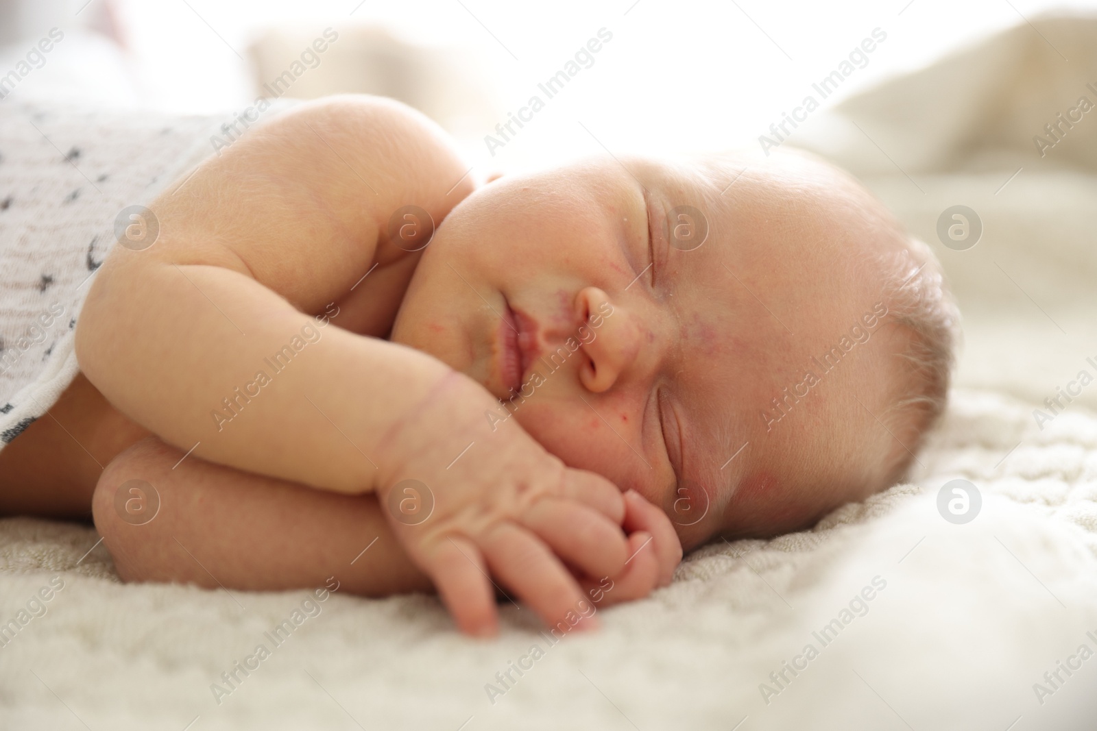 Cute newborn baby sleeping on bed indoors Photo of Cute newborn baby sleeping on bed indoors