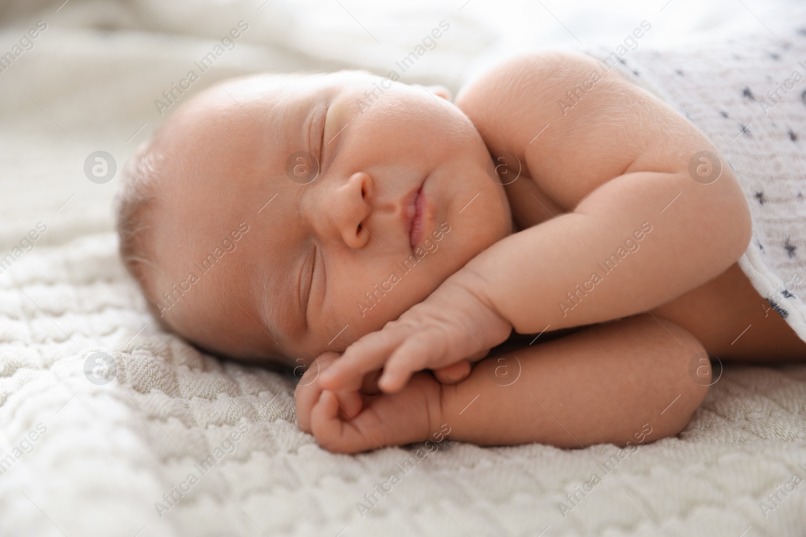Cute newborn baby sleeping on bed indoors Photo of Cute newborn baby sleeping on bed indoors