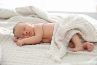 Photo of Cute newborn baby sleeping on bed indoors