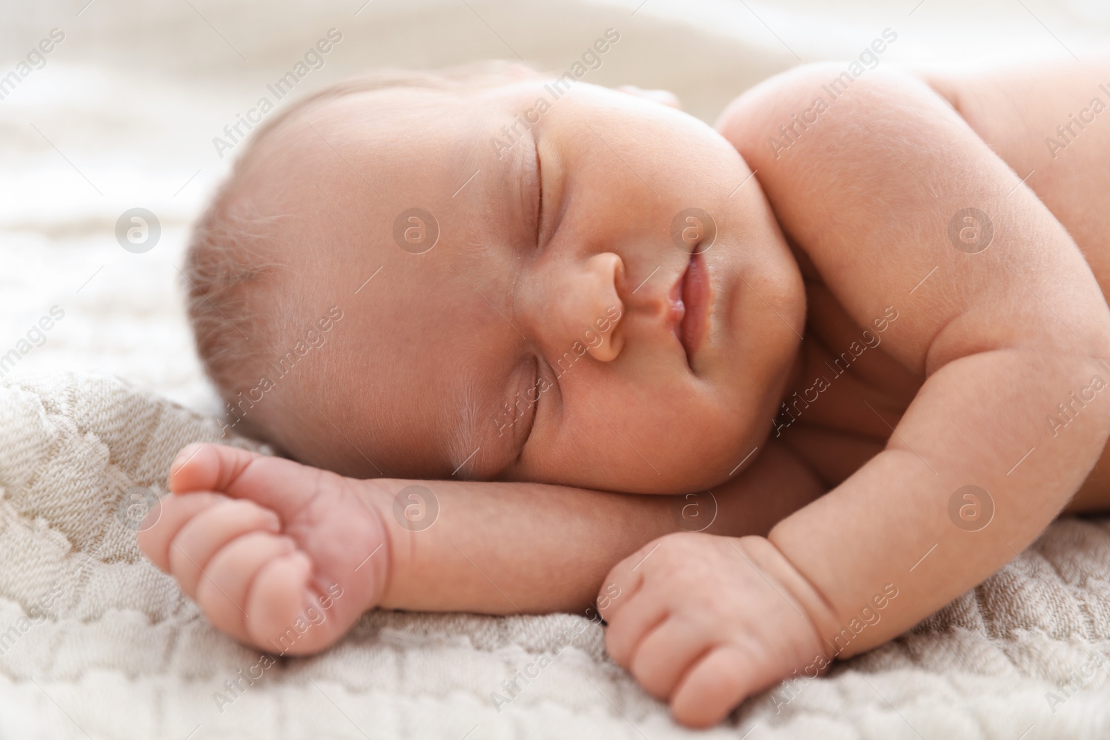 Cute newborn baby sleeping on bed indoors Photo of Cute newborn baby sleeping on bed indoors